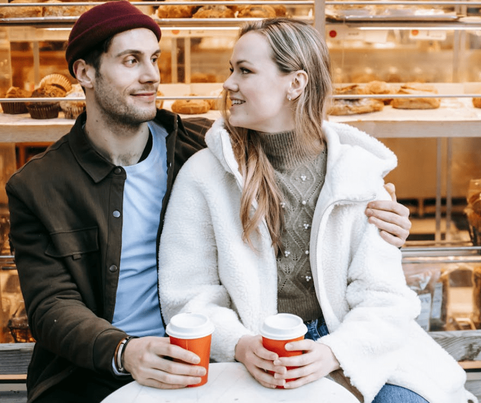 cozy-connection-outdoor-moment.png couples sitting outside of a bakeshop, drinking coffee