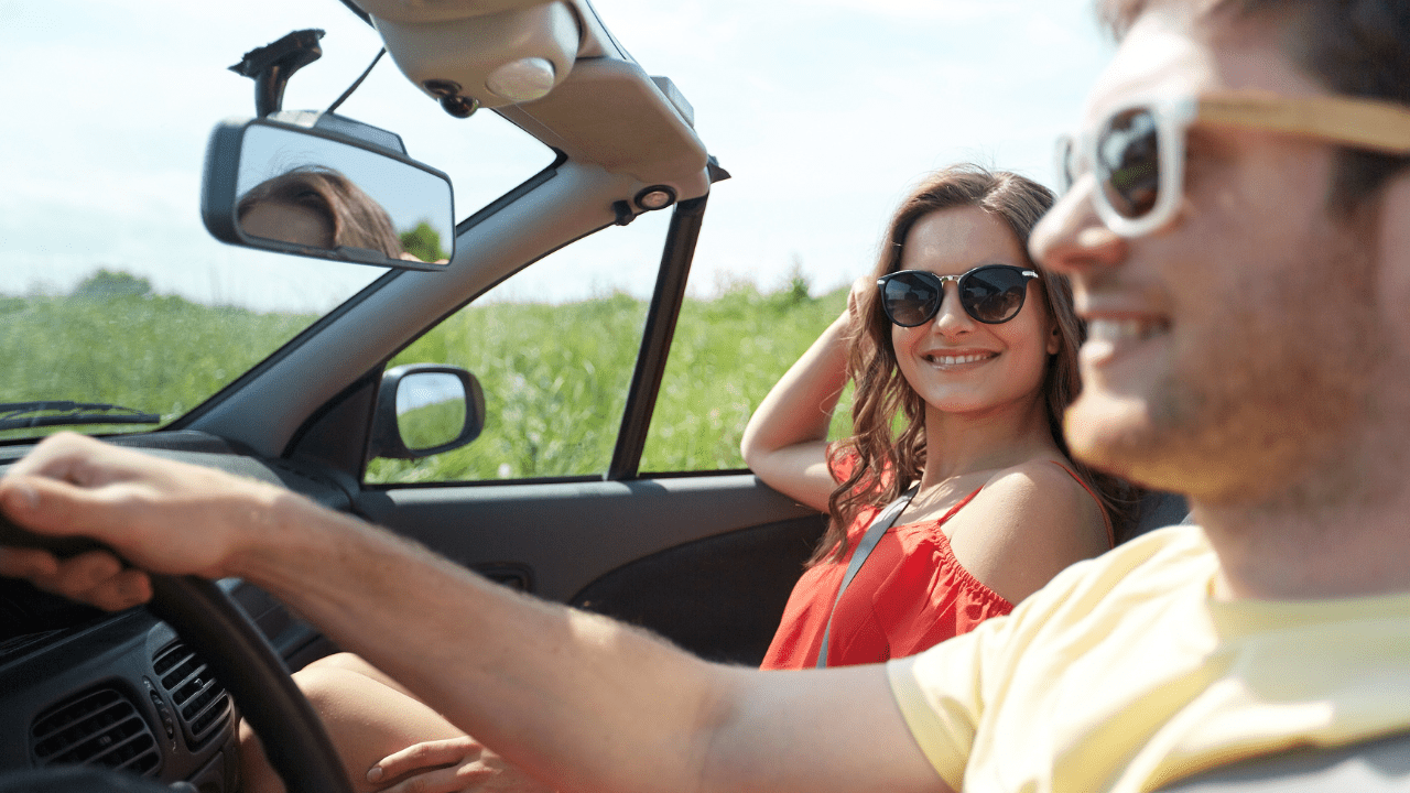 Happy young couple driving together and enjoying their relationship