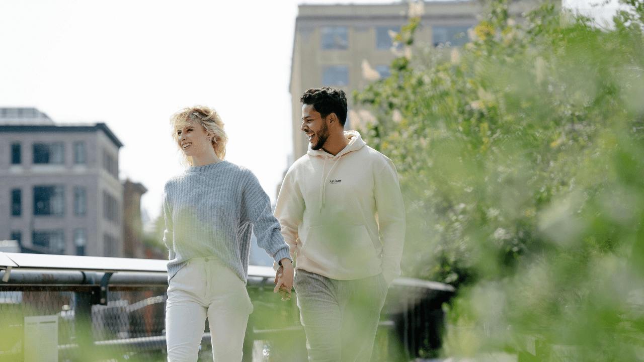Woman and man walking and holding hands