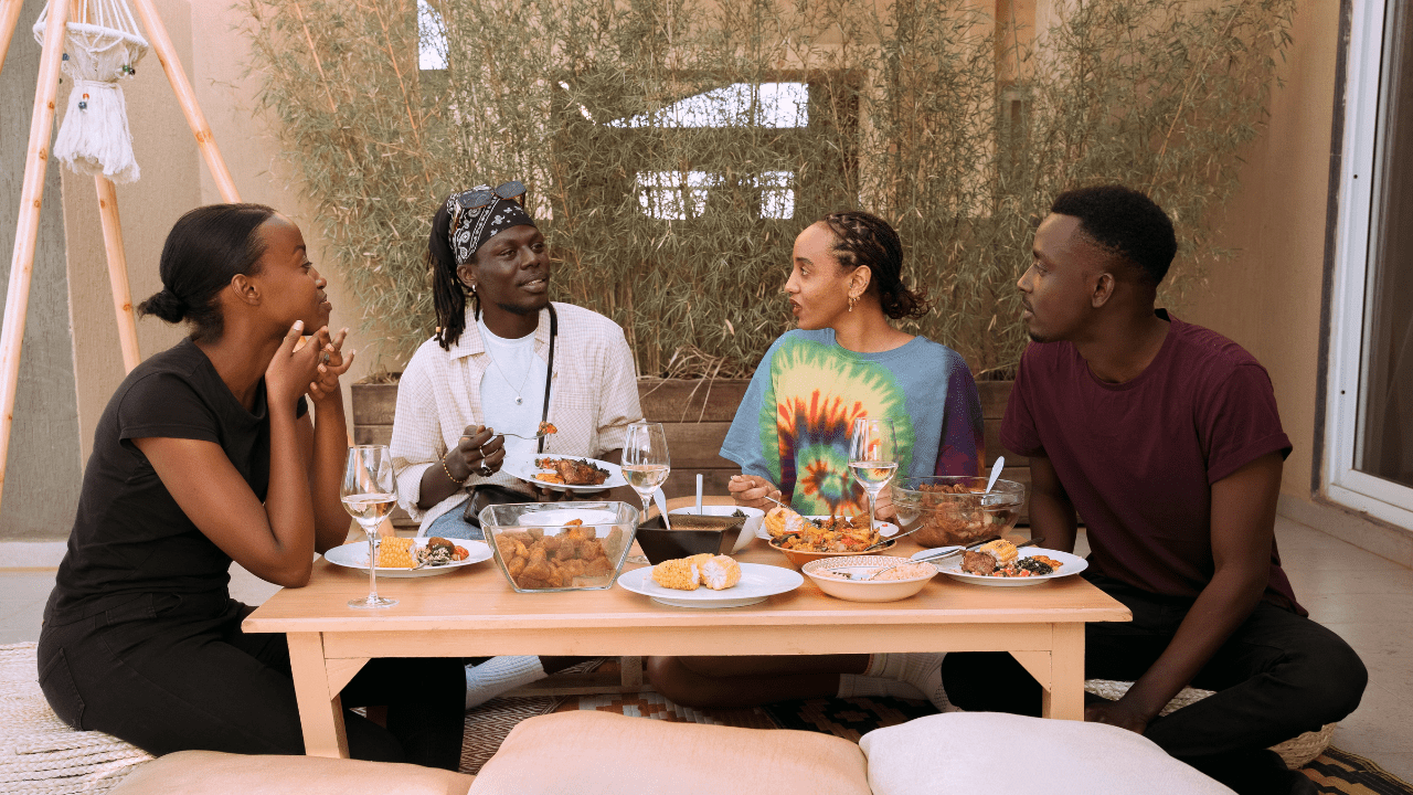 An engaged couple having a conversation with their family while discussing wedding plans