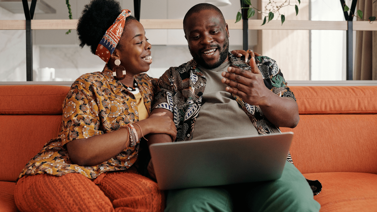 Couple talking while sitting on couch