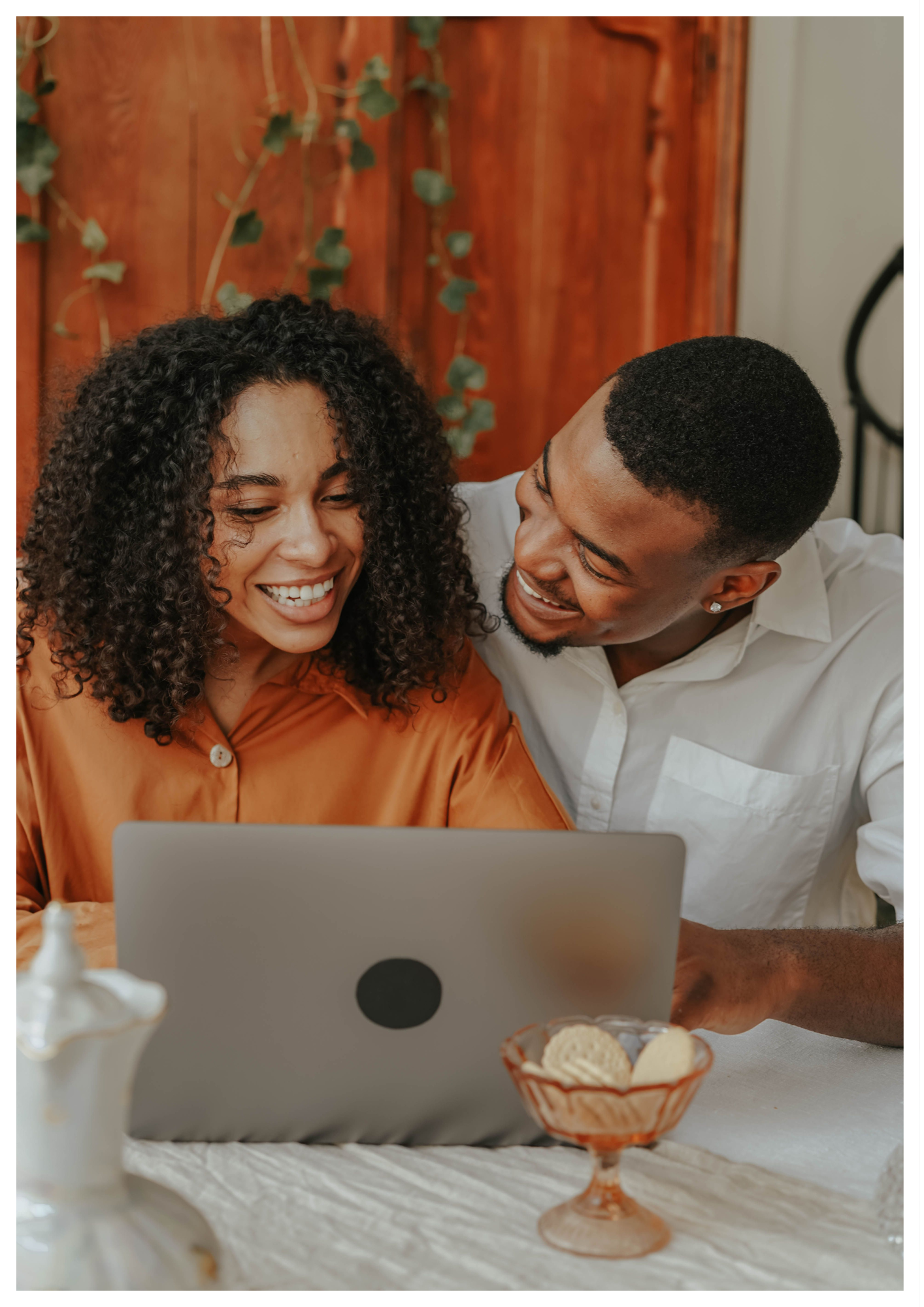 Couple enjoying online couples therapy together using a laptop at home