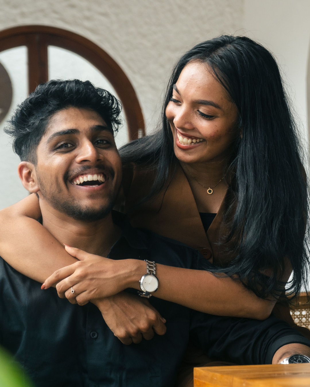 Happy couple laughing together, showing emotional connection and healthy communication in a relationship