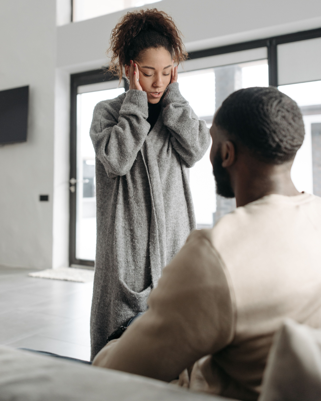 Woman appearing overwhelmed during a difficult relationship conversation